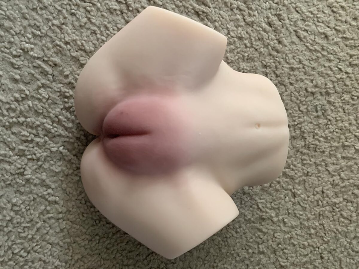 A realistic male masturbator designed to provide lifelike sensations with textured openings for enhanced pleasure.