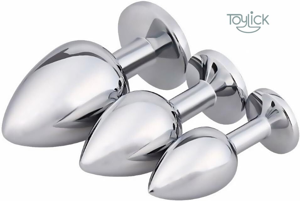 luxury-jewel-butt-plug-3-pieces-collection-toylick-3 A size comparison image of the three-piece Toylick butt plug set. The chrome plugs are shown side-by-side with their dimensions noted: the large is 3.7 by 1.7 inches, the medium is 3.2 by 1.3 inches, and the small is 2.7 by 1.1 inches.The set of three chrome-colored Toylick butt plugs shown in descending size order against a plain white background. This view focuses on the polished metal body of the plugs, with the bases angled away from the camera.